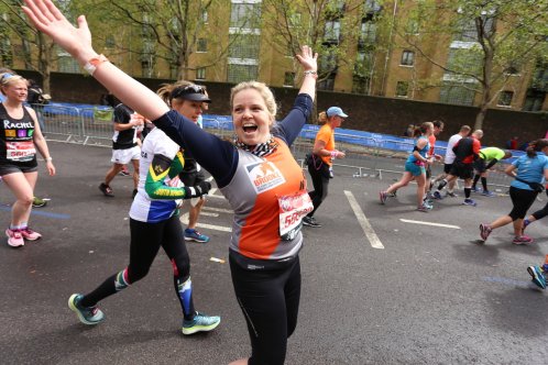 Runner celebrating with arms in the air