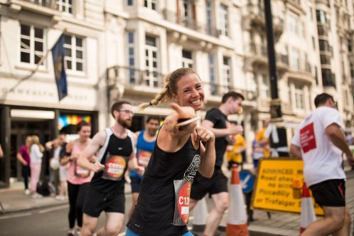 woman pointing at camera whilst running London 10k